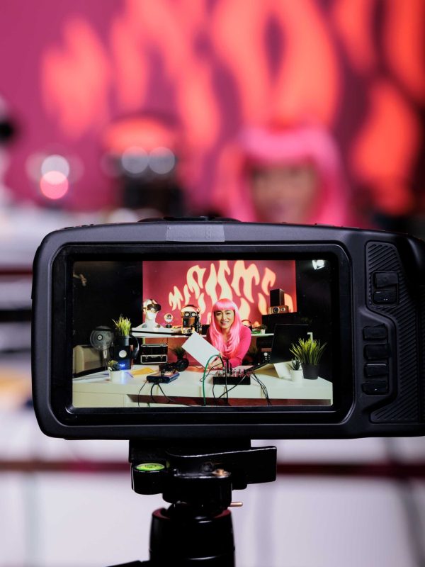 asian-vlogger-advertising-white-box-camera-reviewing-product-while-recording-podcast-vlogging-studio-content-creator-woman-filming-vlog-using-professional-broadcasting-equipment (1)